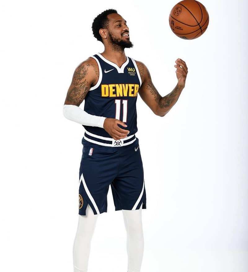 Monté Morris posing in his Denver Nuggets jersey